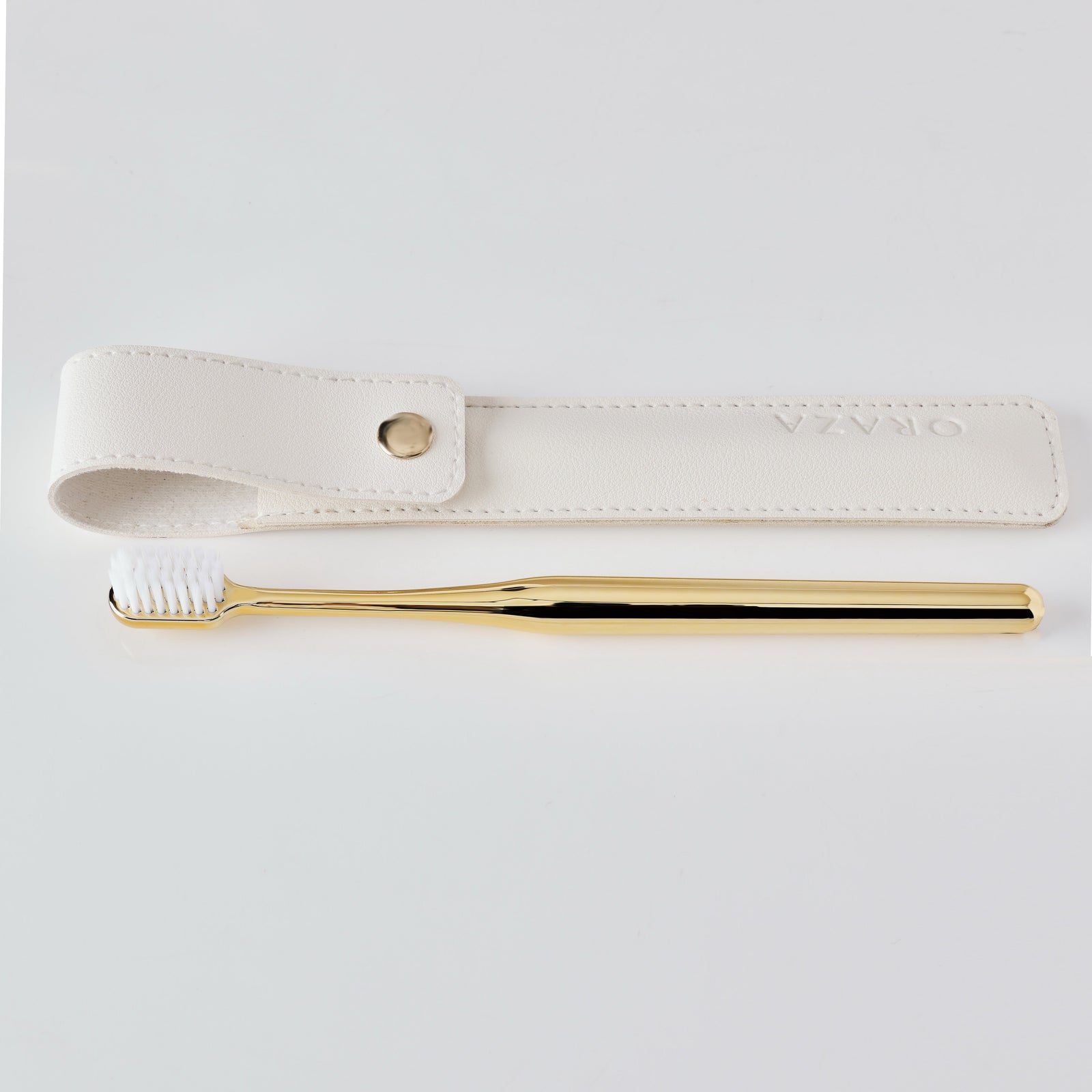 WHITE LEATHER CASE &  GOLD TOOTHBRUSH