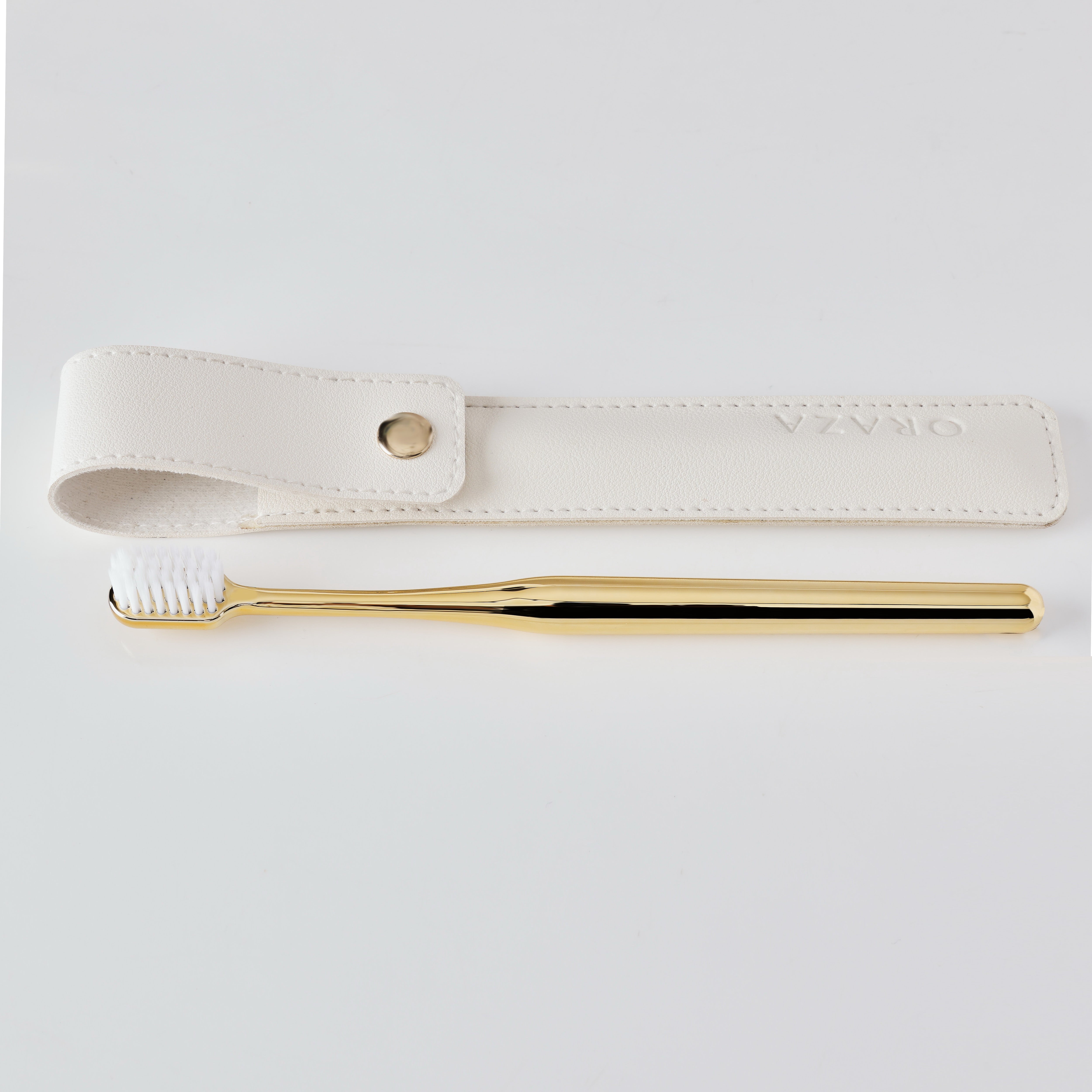 WHITE LEATHER CASE &  GOLD TOOTHBRUSH