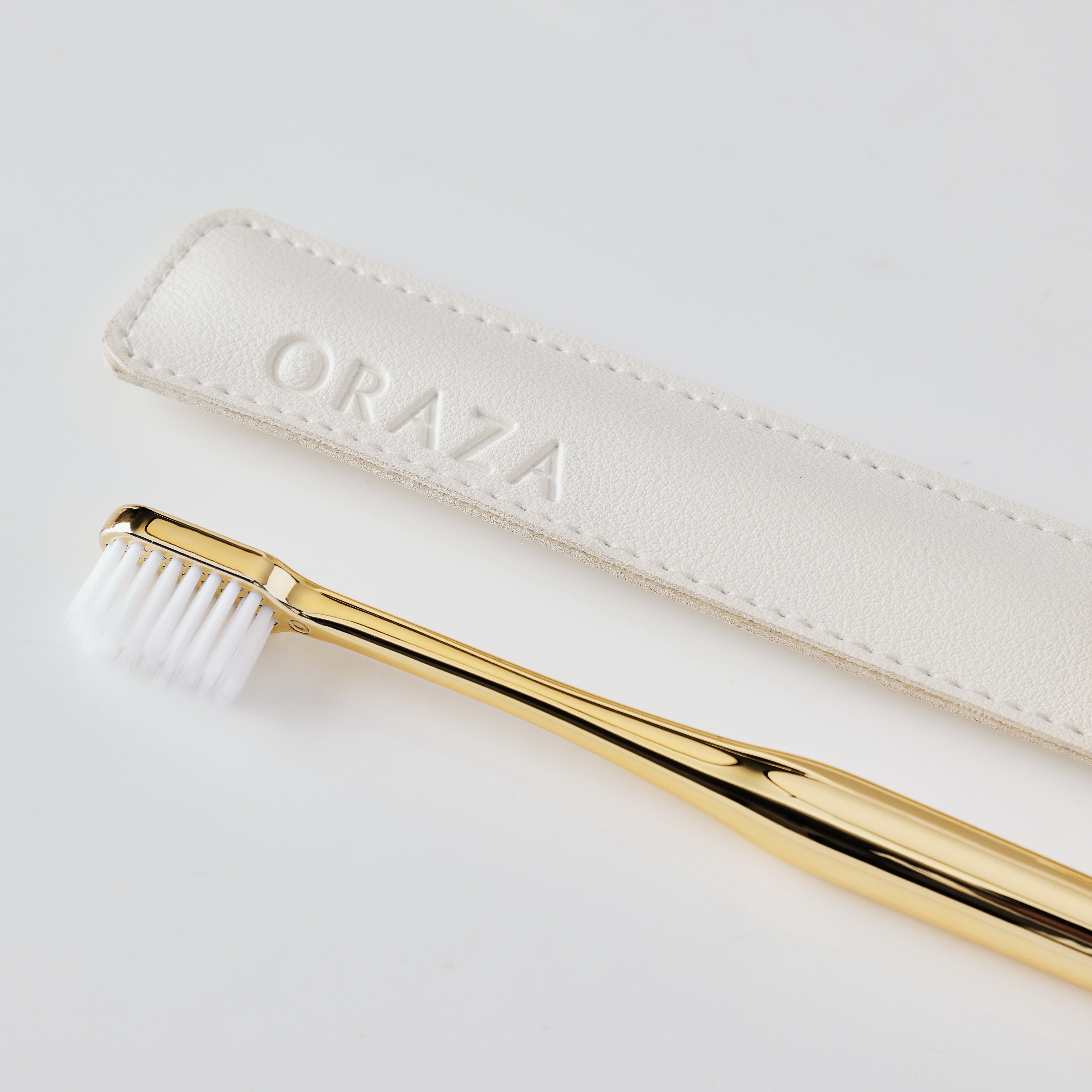 White Leather Case & Gold Toothbrush