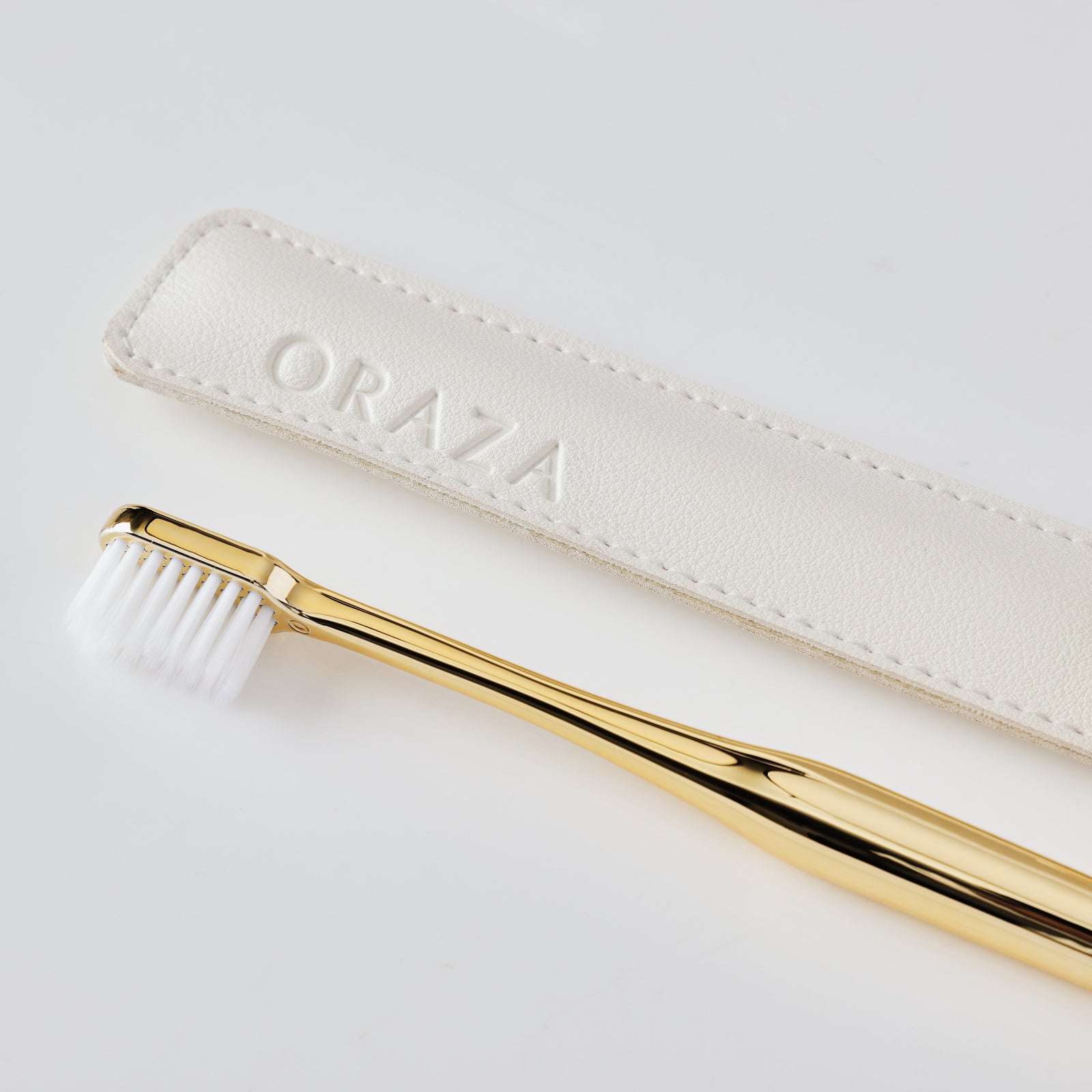 WHITE LEATHER CASE &  GOLD TOOTHBRUSH